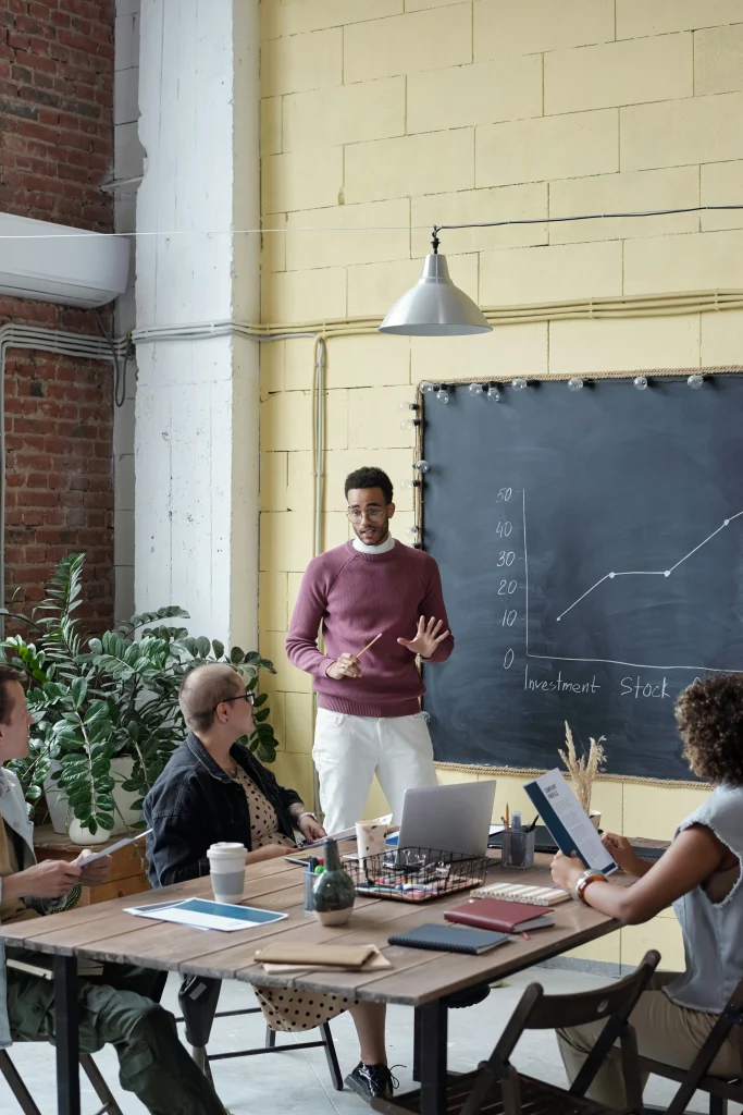 young african american presenting a blackboard