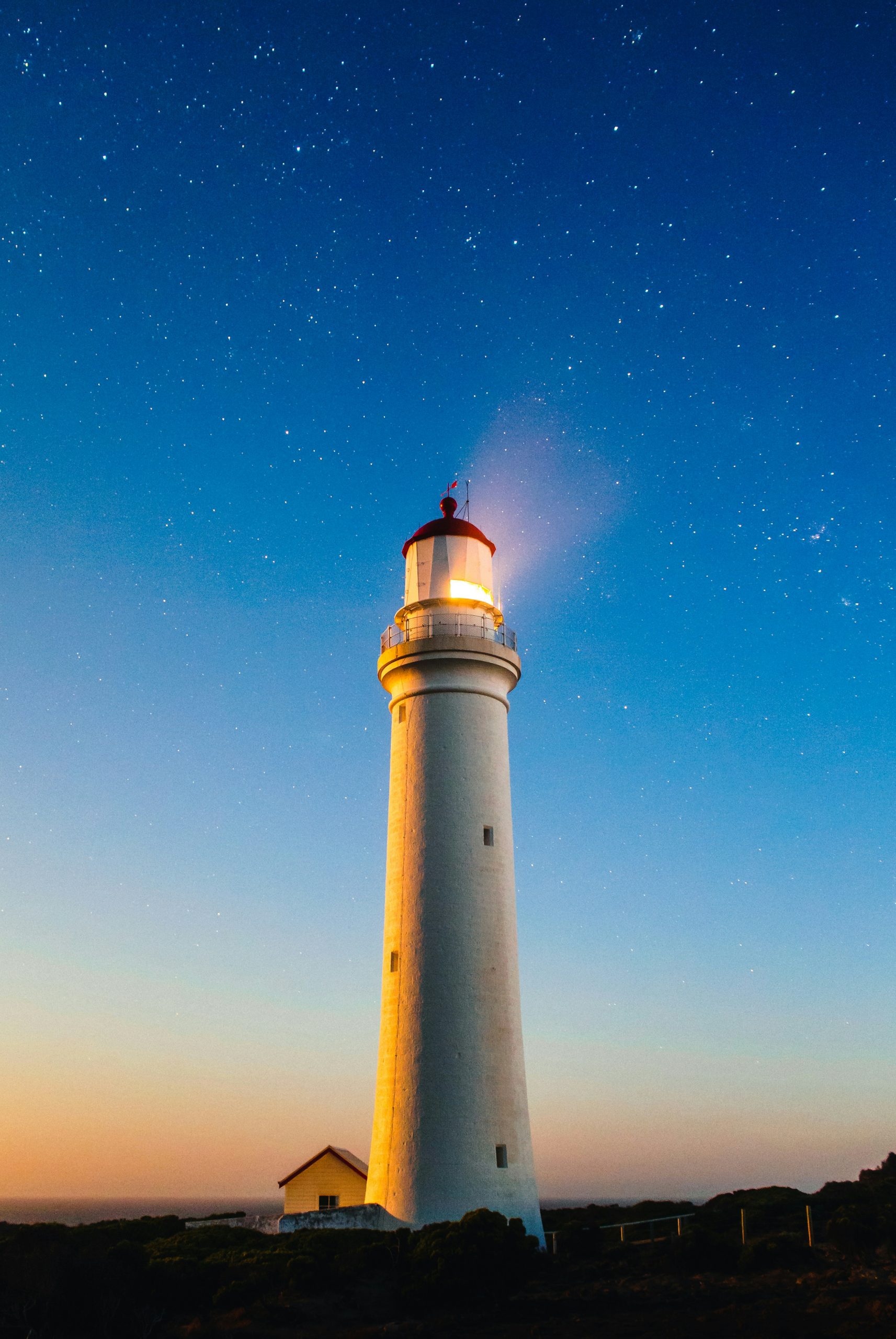 light house in the dark shining a light